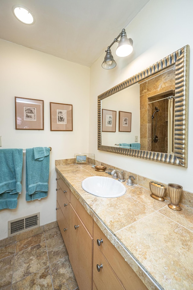 bathroom featuring vanity and walk in shower