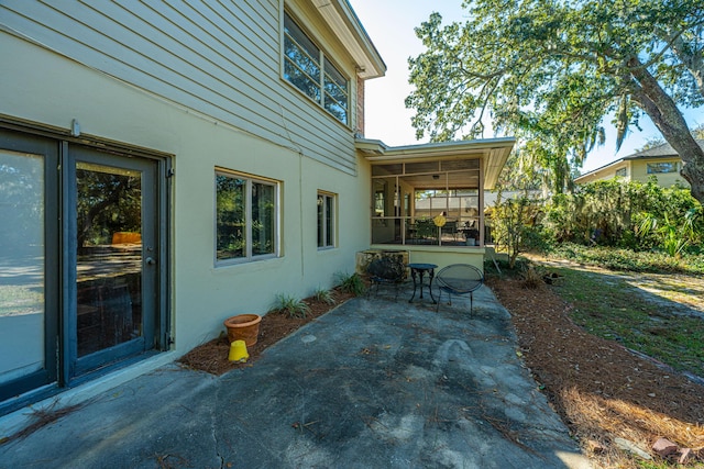 view of patio / terrace featuring a sunroom