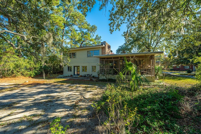 rear view of house with a sunroom