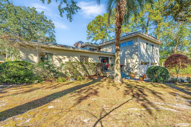 view of front of home featuring a front lawn and a garage