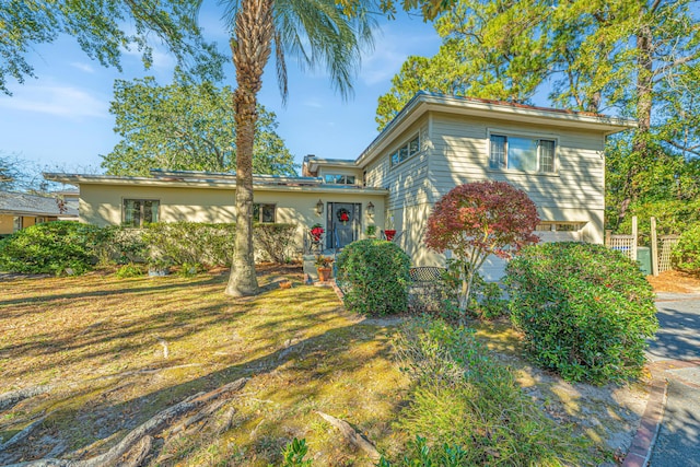 view of front facade with a garage and a front lawn