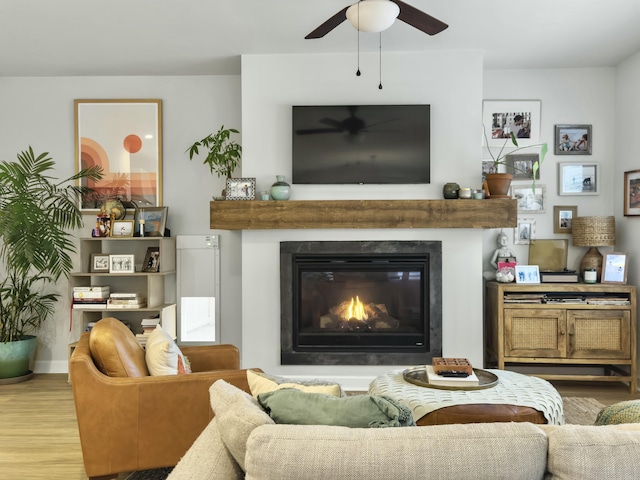 living room featuring ceiling fan and light hardwood / wood-style floors