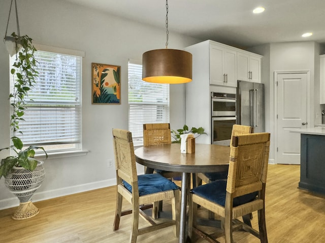 dining space featuring light hardwood / wood-style flooring and a wealth of natural light