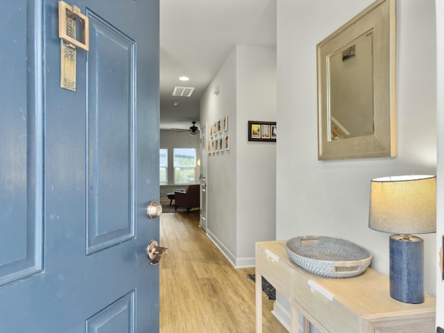 hallway with light hardwood / wood-style floors