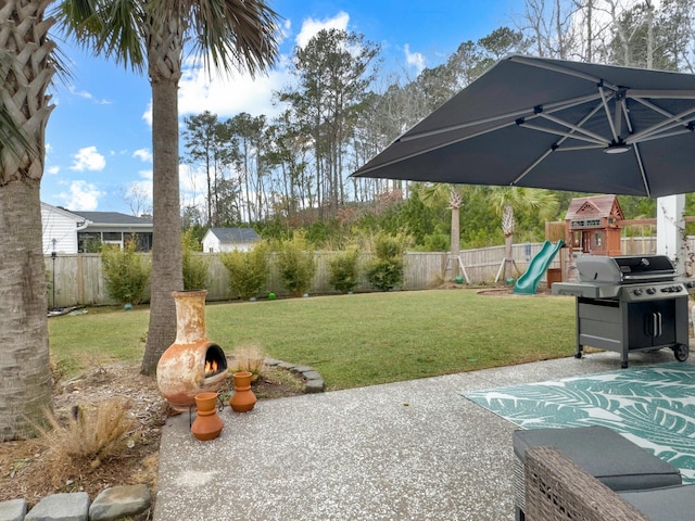 view of yard with a playground and a patio