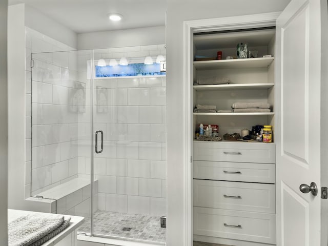 bathroom with a shower with door