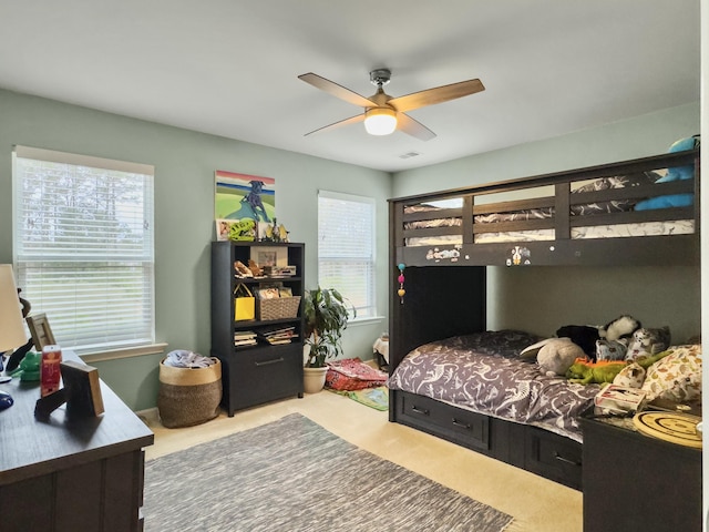 bedroom featuring ceiling fan and carpet