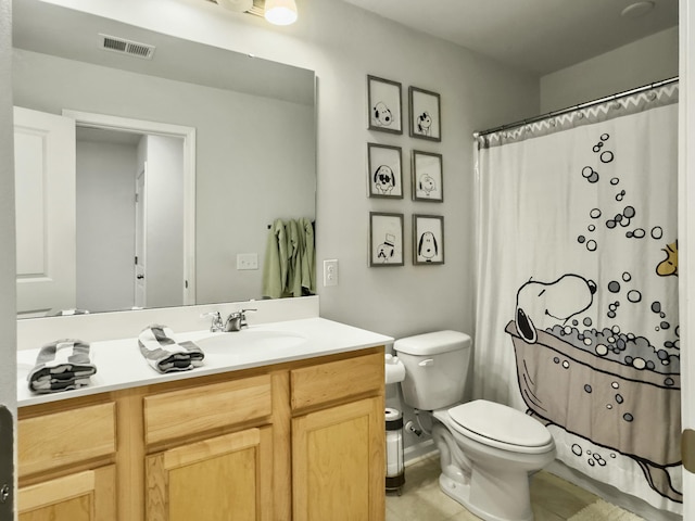 bathroom with tile patterned floors, vanity, and toilet