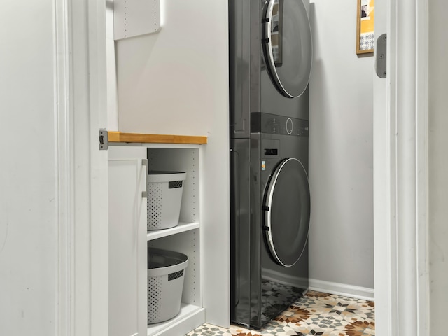 laundry area featuring stacked washer / drying machine