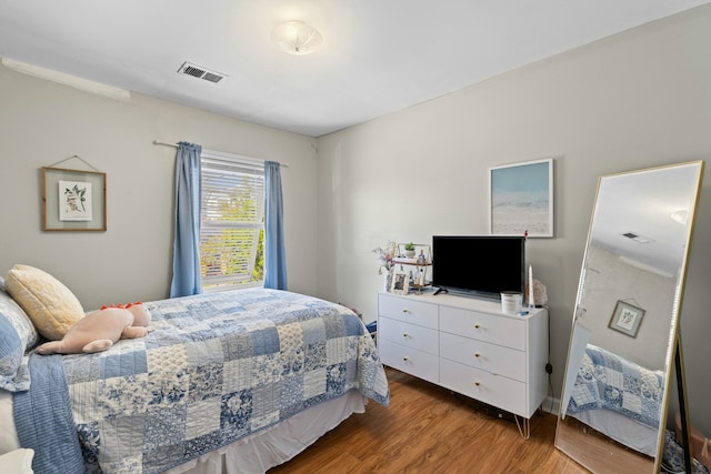 bedroom with visible vents and dark wood finished floors