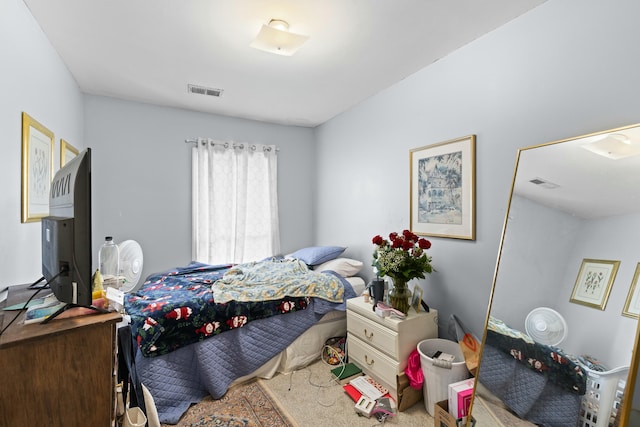 carpeted bedroom featuring visible vents