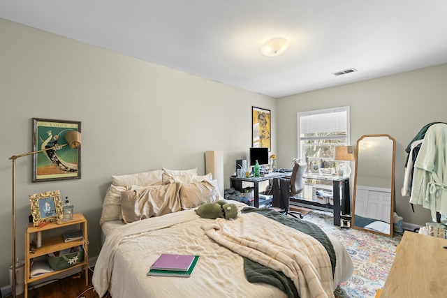 bedroom with visible vents and wood finished floors