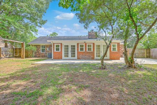 2534 Flamingo Dr, Charleston, SC 29414 - rear view of property featuring french doors, a patio area, a chimney, and brick siding
