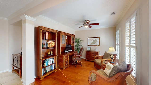 office with a ceiling fan, ornamental molding, wood finished floors, ornate columns, and a textured ceiling