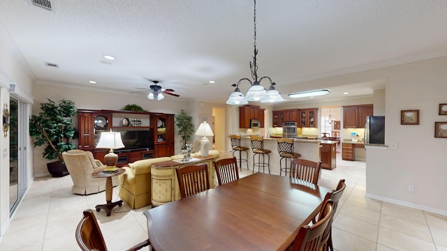dining room featuring crown molding, light tile patterned floors, a ceiling fan, and recessed lighting