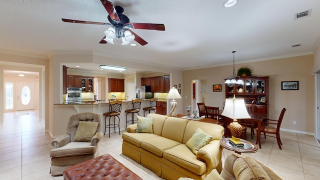 living room featuring light tile patterned flooring, a ceiling fan, ornamental molding, and recessed lighting