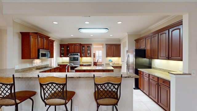 kitchen featuring appliances with stainless steel finishes, a peninsula, a kitchen breakfast bar, glass insert cabinets, and recessed lighting