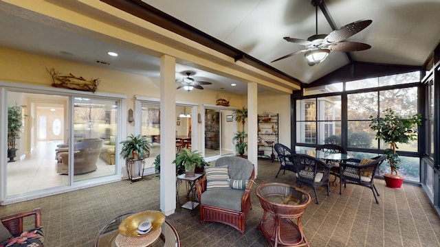 sunroom / solarium with a ceiling fan, healthy amount of natural light, and vaulted ceiling