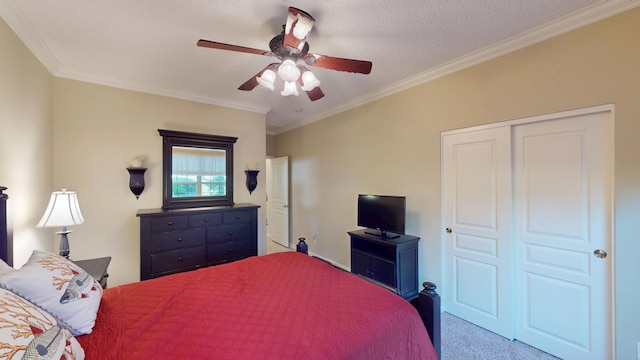 carpeted bedroom with ornamental molding, a closet, and ceiling fan