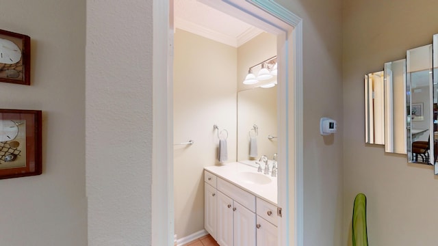 bathroom featuring ornamental molding and vanity