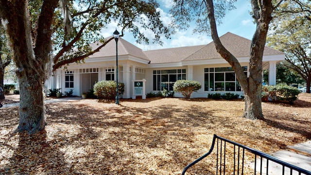 ranch-style home with roof with shingles