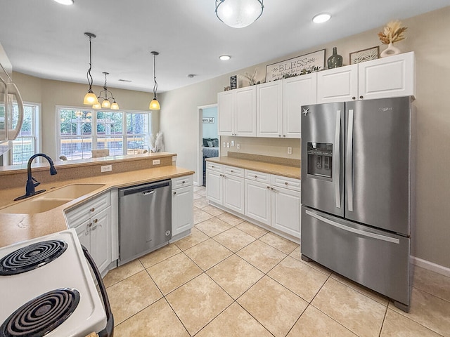 kitchen featuring light tile patterned flooring, stainless steel appliances, a sink, white cabinets, and light countertops