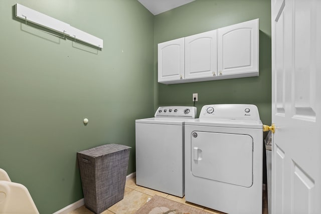 laundry room with cabinet space, light tile patterned floors, baseboards, and independent washer and dryer