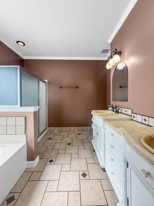 bathroom with double vanity, ornamental molding, a garden tub, a shower stall, and a sink