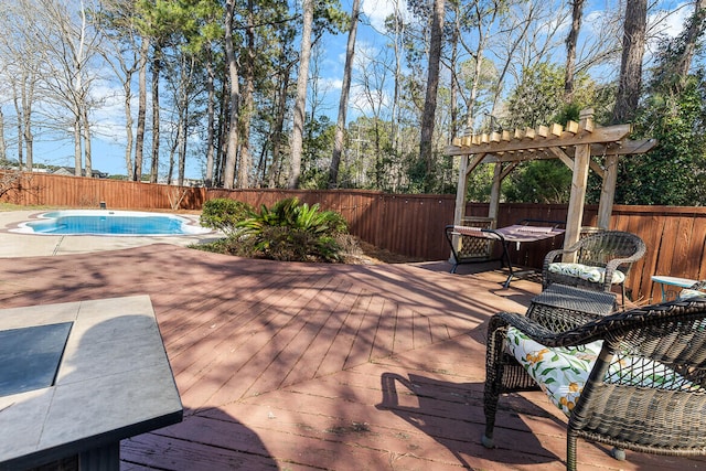 view of patio / terrace featuring a deck, a fenced backyard, a fenced in pool, and a pergola