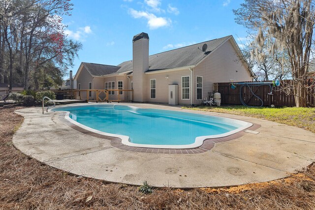 view of pool featuring a patio area and fence