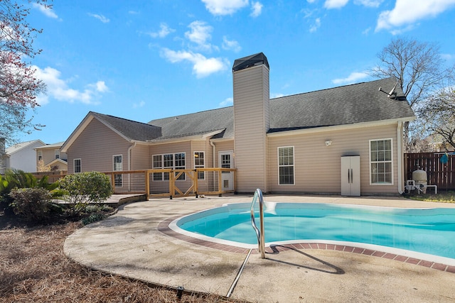 view of swimming pool with a fenced in pool, a patio area, fence, and a wooden deck