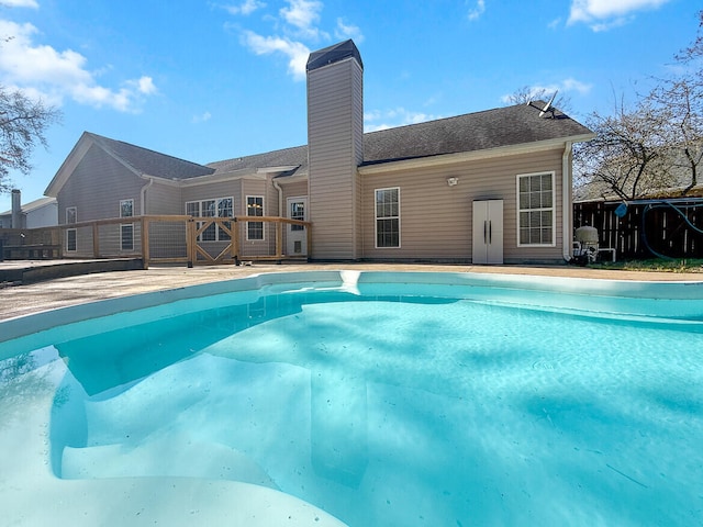 view of swimming pool featuring fence