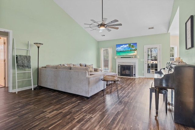 living room featuring high vaulted ceiling, a fireplace, wood finished floors, visible vents, and a ceiling fan