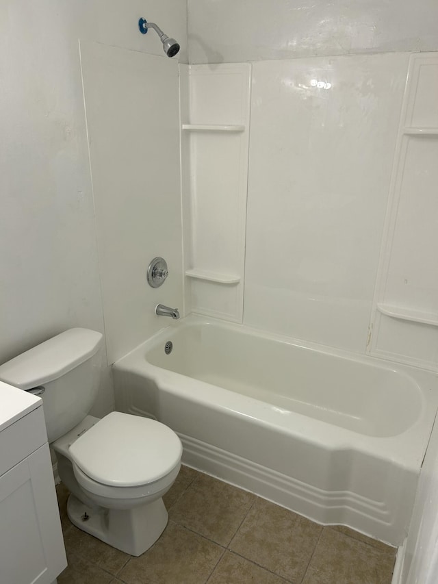 bathroom featuring vanity, toilet, shower / washtub combination, and tile patterned floors