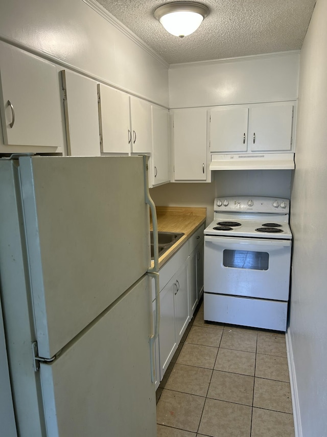 kitchen featuring light tile patterned floors, white cabinetry, a textured ceiling, white appliances, and under cabinet range hood