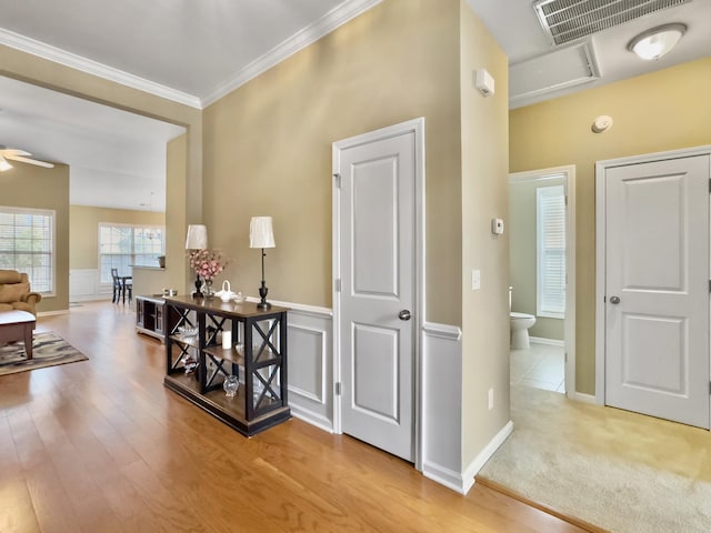 hallway with light carpet and ornamental molding