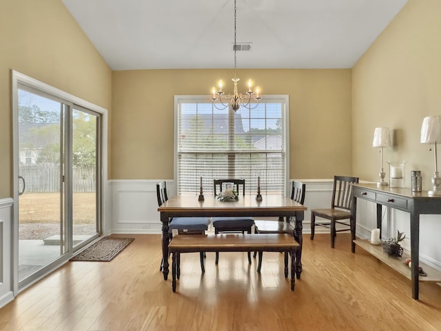 dining area with a chandelier and light hardwood / wood-style floors