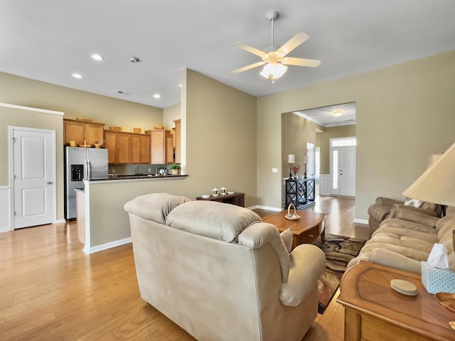 living room with ceiling fan and light hardwood / wood-style floors