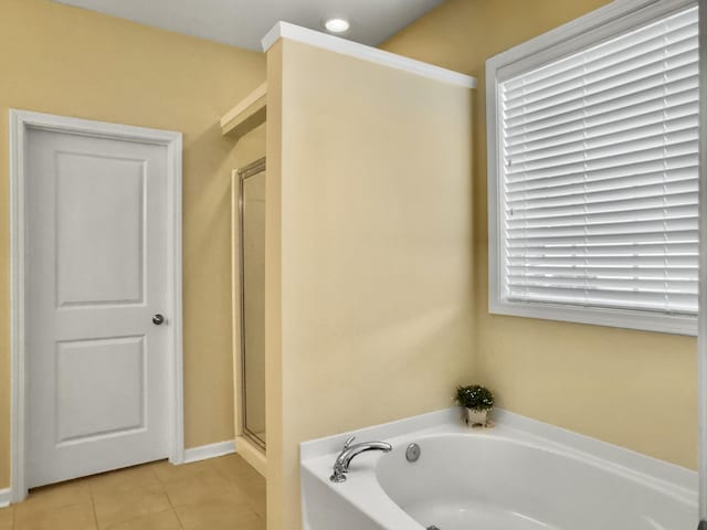 bathroom with tile patterned floors and independent shower and bath