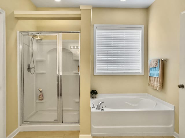 bathroom with tile patterned floors and independent shower and bath