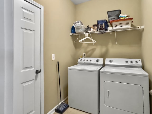 laundry area with light tile patterned floors and separate washer and dryer