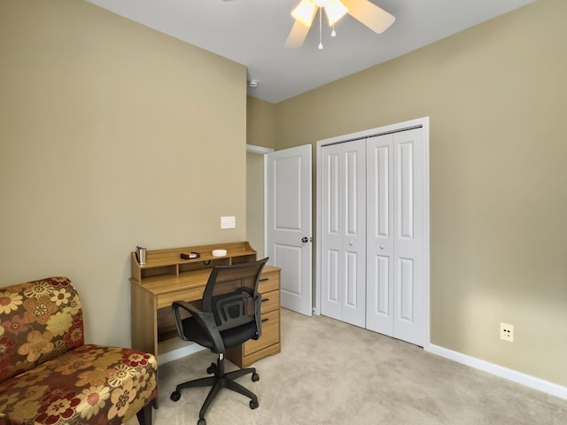 carpeted office featuring ceiling fan