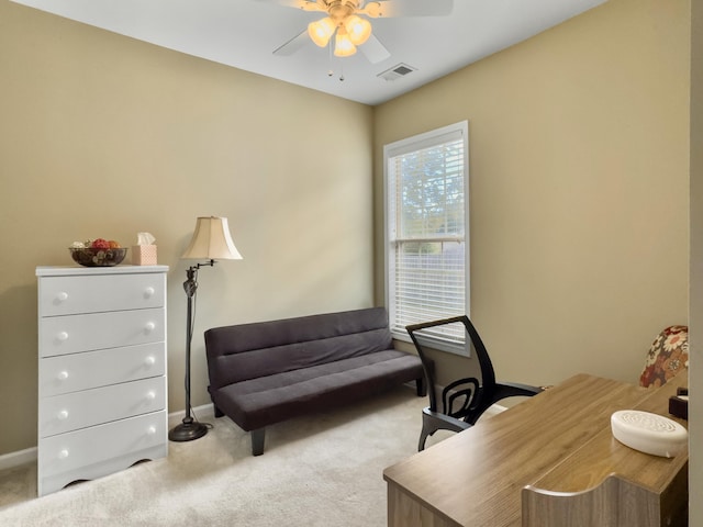 carpeted home office featuring ceiling fan