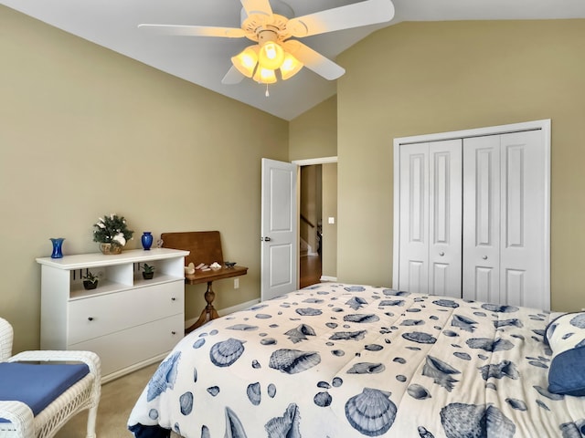 carpeted bedroom with ceiling fan, a closet, and vaulted ceiling