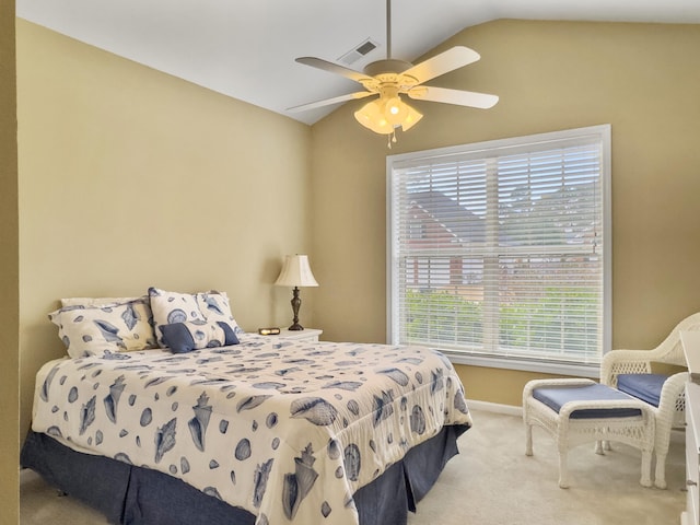 bedroom with light colored carpet, vaulted ceiling, and ceiling fan