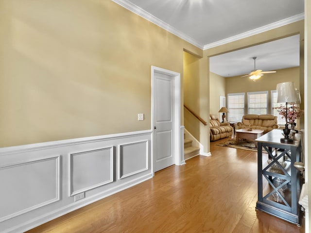 hallway featuring hardwood / wood-style flooring and crown molding