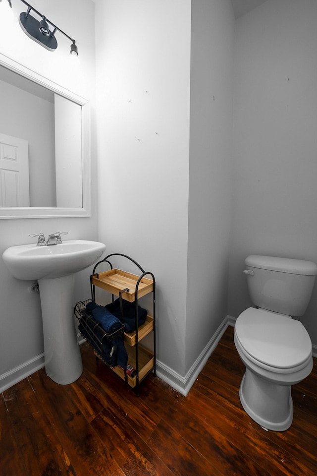 bathroom featuring sink, hardwood / wood-style flooring, and toilet