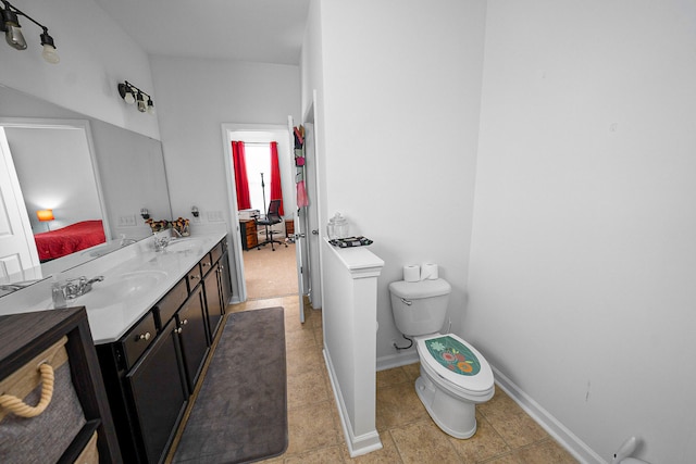 bathroom with vanity, toilet, and tile patterned floors