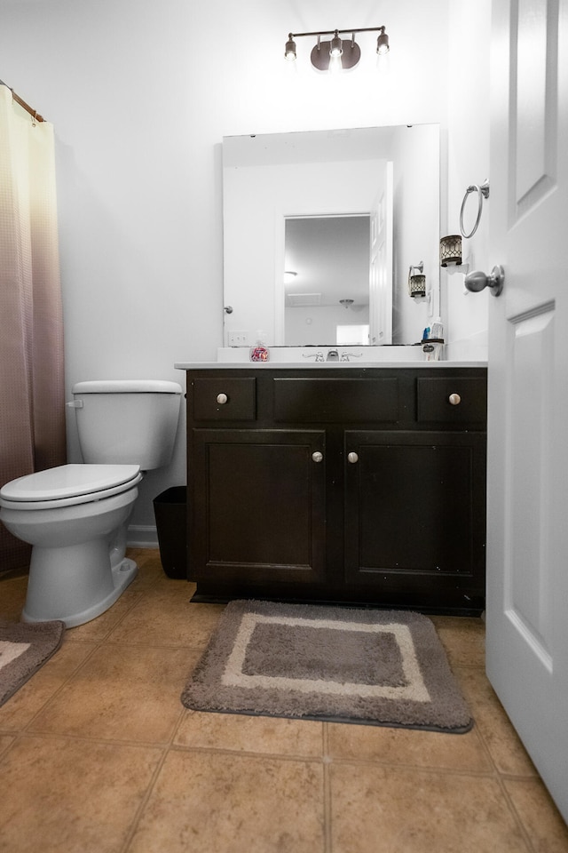 bathroom featuring vanity, toilet, and tile patterned floors