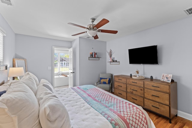 bedroom featuring access to exterior, visible vents, light wood-type flooring, and ceiling fan